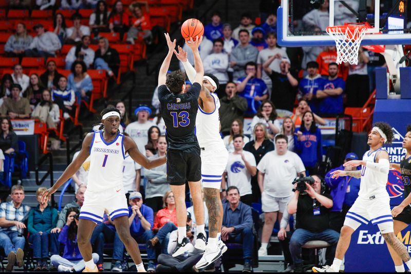 Feb 20, 2024; Boise, Idaho, USA;  San Jose State Spartans guard Alvaro Cardenas (13) shoots over Boise State Broncos guard Chibuzo Agbo (11) during the second half  at  ExtraMile Arena.  Mandatory Credit: Brian Losness-USA TODAY Sports