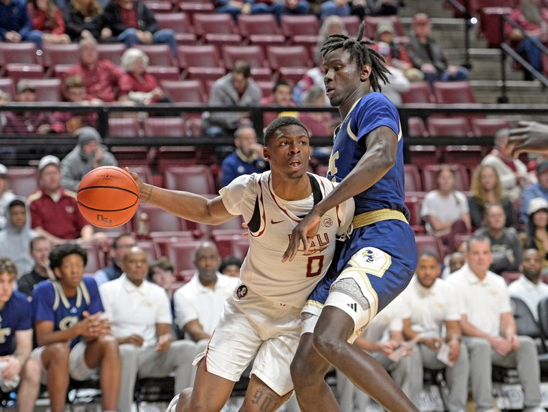 Jan 18, 2025; Tallahassee, Florida, USA; Florida State Seminoles guard Chandler Jackson (0) drives the ball against Georgia Tech Yellowjackets forward Baye Ndongo (11) during the first half at Donald L. Tucker Center. Mandatory Credit: Robert Myers-Imagn Images