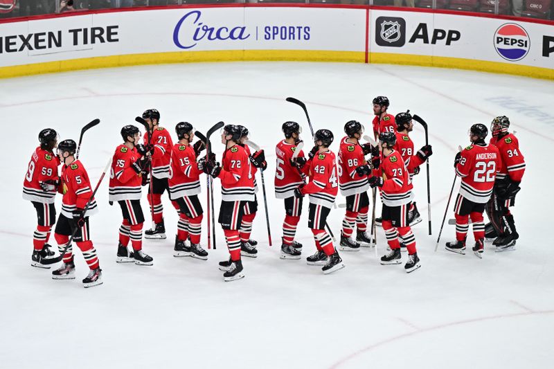 Nov 21, 2024; Chicago, Illinois, USA; The Chicago Blackhawks celebrate their win against the Florida Panthers after the game at the United Center. Mandatory Credit: Daniel Bartel-Imagn Images