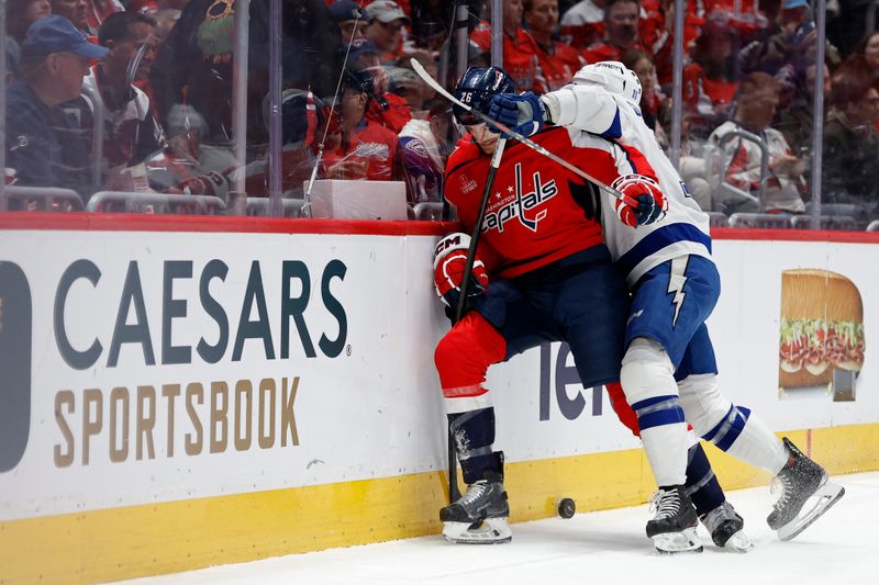 Apr 13, 2024; Washington, District of Columbia, USA;  Washington Capitals center Nic Dowd (26) and Tampa Bay Lightning center Luke Glendening (11) battles for the puck in the first periodat Capital One Arena. Mandatory Credit: Geoff Burke-USA TODAY Sports