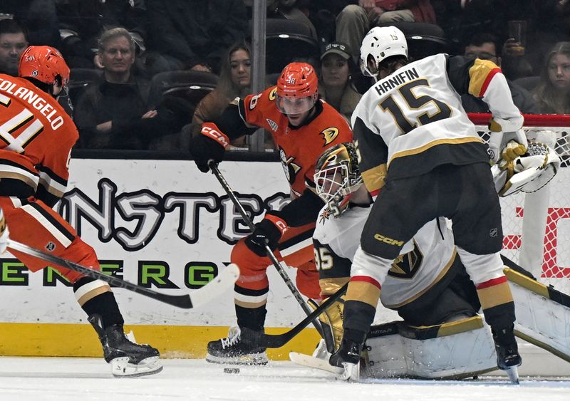 Dec 4, 2024; Anaheim, California, USA;  Vegas Golden Knights goaltender Ilya Samsonov (35) defends with defenseman Noah Hanifin (15) against Anaheim Ducks center Jansen Harkins (38) and right wing Sam Colangelo (64) during the third period at Honda Center. Mandatory Credit: Alex Gallardo-Imagn Images