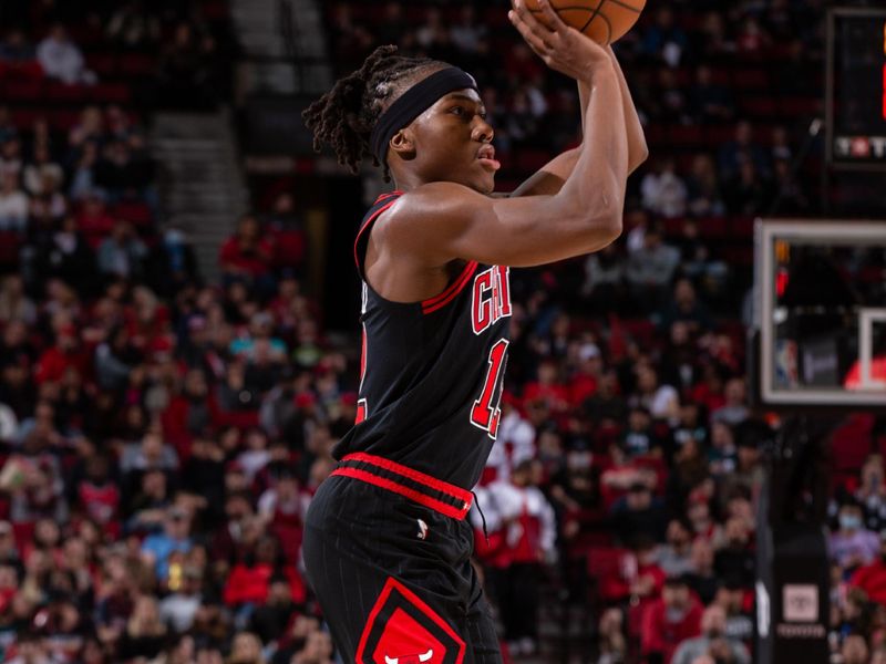 PORTLAND, OR - MARCH 24:  Ayo Dosunmu #12 of the Chicago Bulls shoots a three point basket during the game  on March 24, 2023 at the Moda Center Arena in Portland, Oregon. NOTE TO USER: User expressly acknowledges and agrees that, by downloading and or using this photograph, user is consenting to the terms and conditions of the Getty Images License Agreement. Mandatory Copyright Notice: Copyright 2023 NBAE (Photo by Cameron Browne/NBAE via Getty Images)