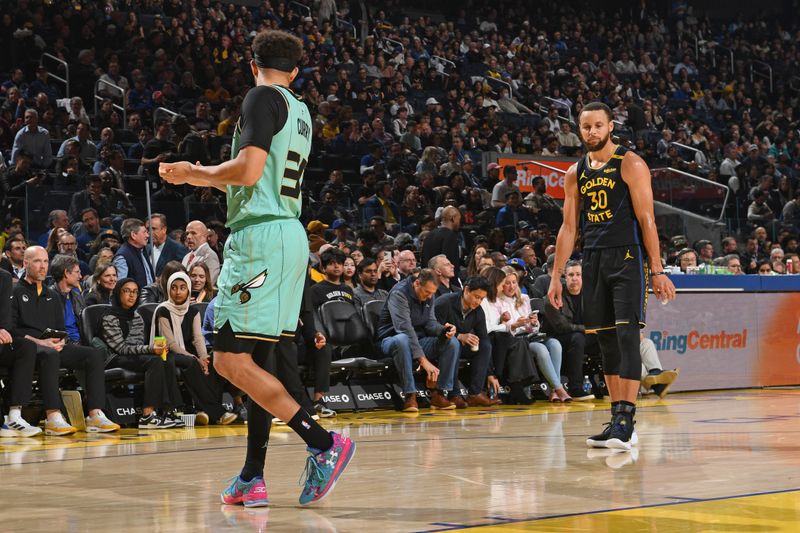 SAN FRANCISCO, CA - FEBRUARY 25: Seth Curry #30 of the Charlotte Hornets and Stephen Curry #30 of the Golden State Warriors look on during the game on February 25, 2025 at Chase Center in San Francisco, California. NOTE TO USER: User expressly acknowledges and agrees that, by downloading and or using this photograph, user is consenting to the terms and conditions of Getty Images License Agreement. Mandatory Copyright Notice: Copyright 2025 NBAE (Photo by Noah Graham/NBAE via Getty Images)