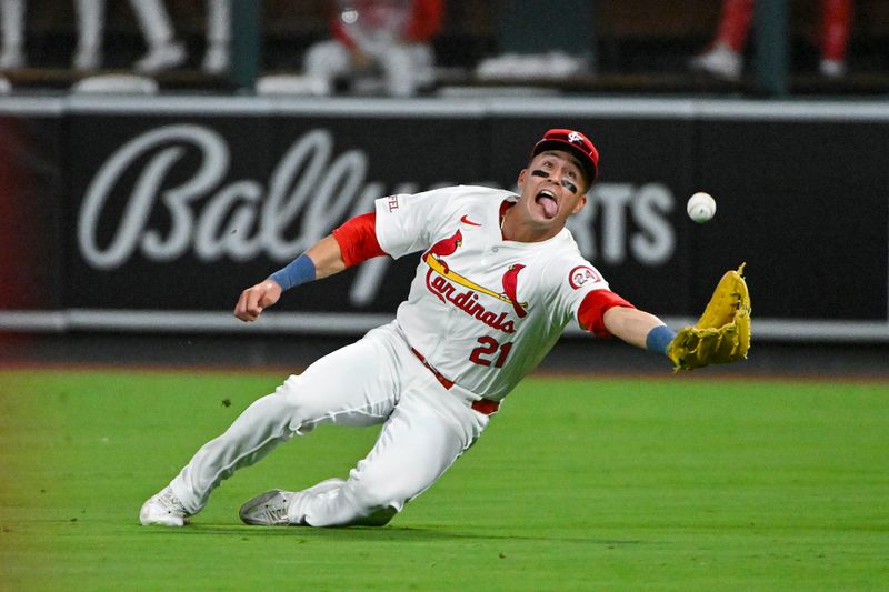 Aug 20, 2024; St. Louis, Missouri, USA;  St. Louis Cardinals right fielder Lars Nootbaar (21) dives and catches a fly ball against the Milwaukee Brewers during the seventh inning at Busch Stadium. Mandatory Credit: Jeff Curry-USA TODAY Sports