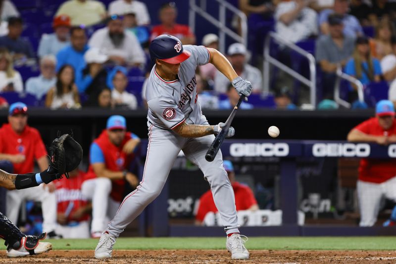 Apr 27, 2024; Miami, Florida, USA; Washington Nationals designated hitter Nick Senzel (13) bunts against the Miami Marlins during the fifth inning at loanDepot Park. Mandatory Credit: Sam Navarro-USA TODAY Sports