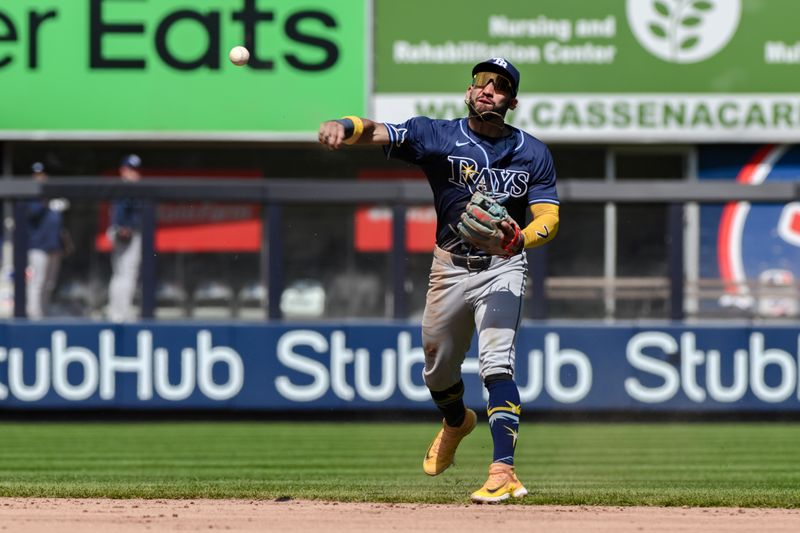 Apr 20, 2024; Bronx, New York, USA; Tampa Bay Rays shortstop José Caballero (7) fields a ground ball and throws to first base for an out during the eighth inning against the New York Yankees at Yankee Stadium. Mandatory Credit: John Jones-USA TODAY Sports