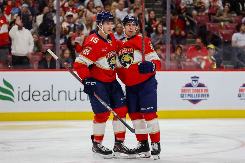 Nov 7, 2024; Sunrise, Florida, USA; Florida Panthers center Evan Rodrigues (17) celebrates with center Anton Lundell (15) after scoring against the Nashville Predators during the second period at Amerant Bank Arena. Mandatory Credit: Sam Navarro-Imagn Images