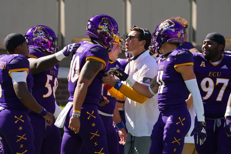 Oct 17, 2020; Greenville, North Carolina, USA;  East Carolina Pirates quarterback Mason Garcia (10) is congratulated by his teammates after his touchdown run against the Navy Midshipmen at Dowdy-Ficklen Stadium. Mandatory Credit: James Guillory-USA TODAY Sports