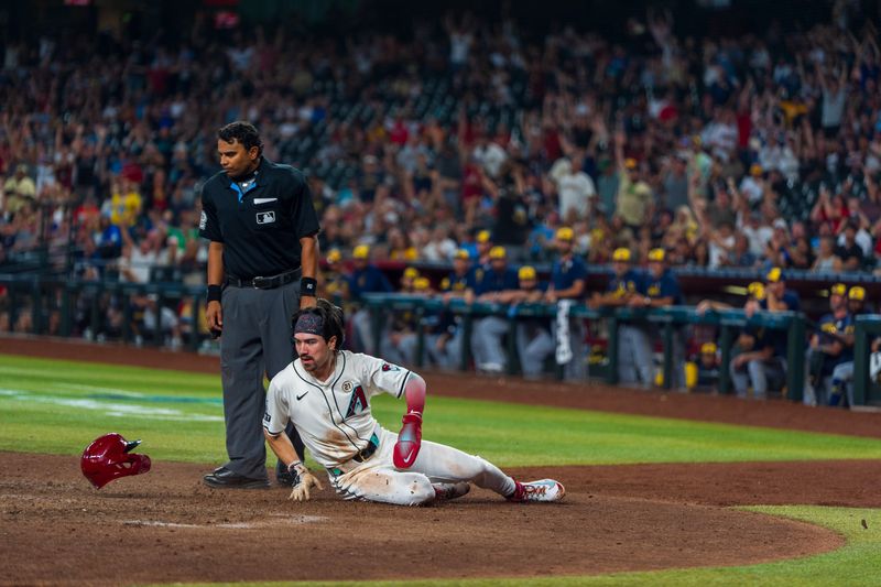 Sep 15, 2024; Phoenix, Arizona, USA; Arizona Diamondbacks outfielder Corbin Carroll (7) loses his helmet as he slides in to score in the eighth inning during a game against the Milwaukee Brewers at Chase Field. Mandatory Credit: Allan Henry-Imagn Images