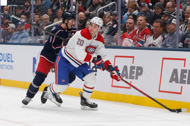 Nov 17, 2025; Columbus, Ohio, USA; Montreal Canadiens left wing Juraj Slafkovsky (20) looks to pass as Columbus Blue Jackets defenseman Zach Werenski (8) defends during the first period at Nationwide Arena. Mandatory Credit: Russell LaBounty-Imagn Images