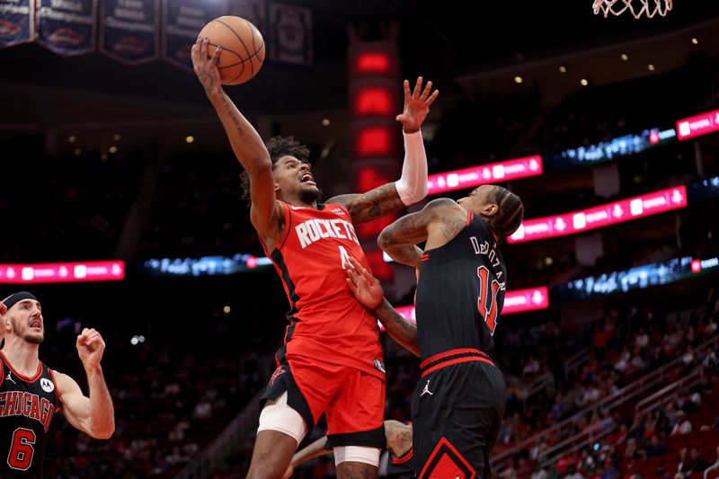 HOUSTON, TEXAS - MARCH 21: Jalen Green #4 of the Houston Rockets goes up for a shot against DeMar DeRozan #11 of the Chicago Bulls in the first half at Toyota Center on March 21, 2024 in Houston, Texas.  NOTE TO USER: User expressly acknowledges and agrees that, by downloading and or using this photograph, User is consenting to the terms and conditions of the Getty Images License Agreement. (Photo by Tim Warner/Getty Images)
