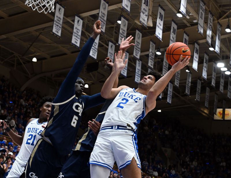 Dec 31, 2025; Durham, North Carolina, USA; Duke Blue Devils guard Cayden Boozer (2) shoots over Georgia Tech Yellow Jackets center Mouhamed Sylia (6) during the second half at Cameron Indoor Stadium.   The Blue Devils won 85-79.  Mandatory Credit: Rob Kinnan-Imagn Images