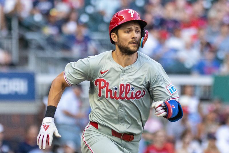 Aug 22, 2024; Cumberland, Georgia, USA; Philadelphia Phillies shortstop Trea Turner (7) runs to first base before getting thrown out at first base against the Atlanta Braves during the first inning at Truist Park. Mandatory Credit: Jordan Godfree-USA TODAY Sports