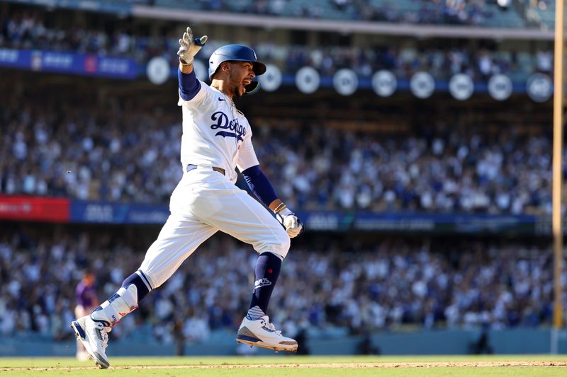 Sep 22, 2024; Los Angeles, California, USA;  Los Angeles Dodgers right fielder Mookie Betts (50) celebrates on game winning home run in bottom of the ninth inning against the Colorado Rockies at Dodger Stadium. Mandatory Credit: Kiyoshi Mio-Imagn Images