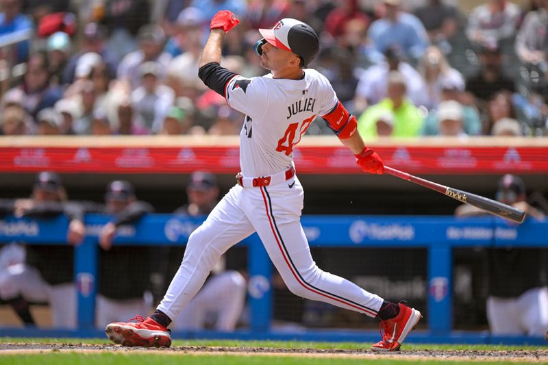 May 27, 2024; Minneapolis, Minnesota, USA; Minnesota Twins infielder Edouard Julien (47) hits a single against the Kansas City Royals during the third inning at Target Field. Mandatory Credit: Nick Wosika-USA TODAY Sports