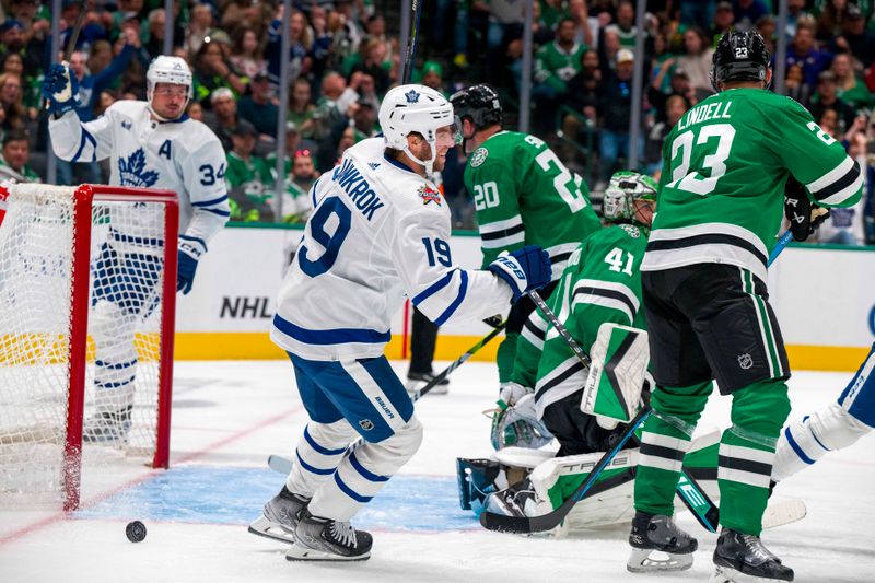 Oct 26, 2023; Dallas, Texas, USA; Toronto Maple Leafs center Auston Matthews (34) and center Calle Jarnkrok (19) celebrates a goal scored by left wing Tyler Bertuzzi (not pictured) against the Dallas Stars during the third period at the American Airlines Center. Mandatory Credit: Jerome Miron-USA TODAY Sports