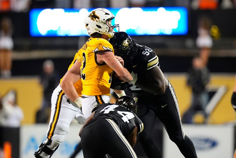 Sep 20, 2025; Boulder, Colorado, USA; Colorado Buffaloes defensive tackle Anquin Barnes Jr. (92) hits Wyoming Cowboys quarterback Kaden Anderson (12) in the second half at Folsom Field. Mandatory Credit: Ron Chenoy-Imagn Images