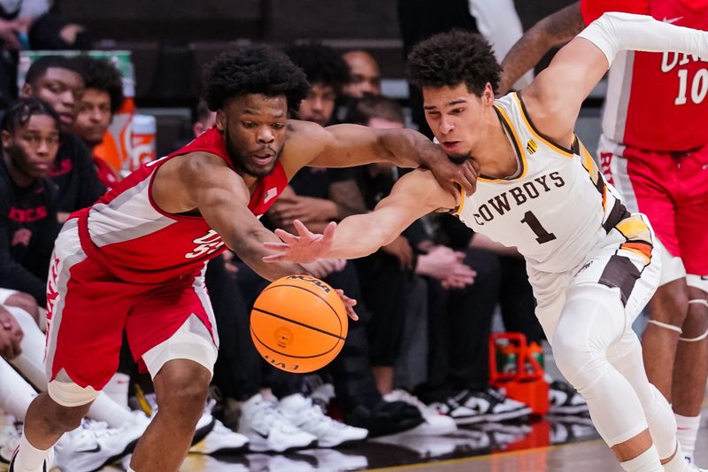 Feb 8, 2023; Laramie, Wyoming, USA; UNLV Runnin' Rebels guard EJ Harkless (55) battles Wyoming Cowboys guard Brendan Wenzel (1) for the loose ball during the second half at Arena-Auditorium. Mandatory Credit: Troy Babbitt-USA TODAY Sports