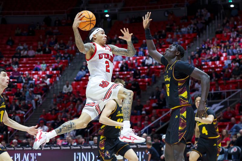Feb 4, 2026; Salt Lake City, Utah, USA; Utah Utes guard Terrence Brown (2) goes to the basket against Arizona State Sun Devils center Massamba Diop (35) during the second half at Jon M. Huntsman Center. Mandatory Credit: Rob Gray-Imagn Images