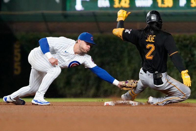Sep 21, 2023; Chicago, Illinois, USA; Pittsburgh Pirates designated hitter Connor Joe (2) is tagged out at second base by Chicago Cubs second baseman Nico Hoerner (2) against the Chicago Cubs during the eighth inning at Wrigley Field. Mandatory Credit: David Banks-USA TODAY Sports