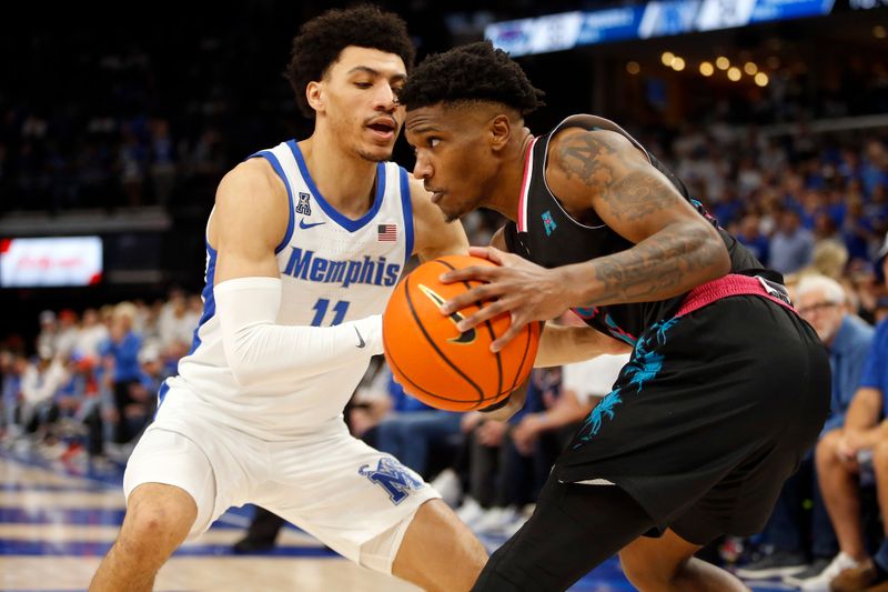 Feb 25, 2024; Memphis, Tennessee, USA; Florida Atlantic Owls guard Brandon Weatherspoon (23) dribbles as Memphis Tigers guard Jahvon Quinerly (11) defends during the second half at FedExForum. Mandatory Credit: Petre Thomas-USA TODAY Sports