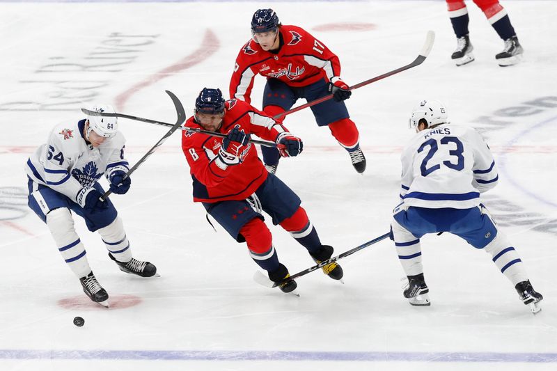 Oct 24, 2023; Washington, District of Columbia, USA; Washington Capitals left wing Alex Ovechkin (8) battle for the puck with Toronto Maple Leafs center David Kampf (64) and Maple Leafs left wing Matthew Knies (23) in the first period at Capital One Arena. Mandatory Credit: Geoff Burke-USA TODAY Sports