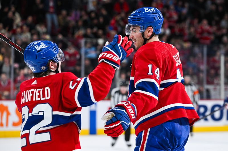 Feb 13, 2024; Montreal, Quebec, CAN; Montreal Canadiens center Nick Suzuki (14) celebrates his second goal of the game against the Anaheim Ducks with right wing Cole Caufield (22) during the second period at Bell Centre. Mandatory Credit: David Kirouac-USA TODAY Sports