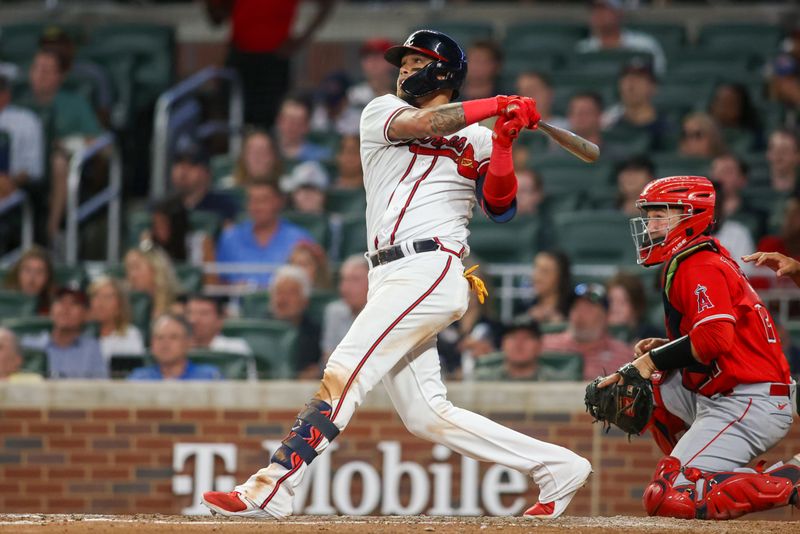 Aug 1, 2023; Atlanta, Georgia, USA; Atlanta Braves shortstop Orlando Arcia (11) hits a two-run home run against the Los Angeles Angels in the seventh inning at Truist Park. Mandatory Credit: Brett Davis-USA TODAY Sports