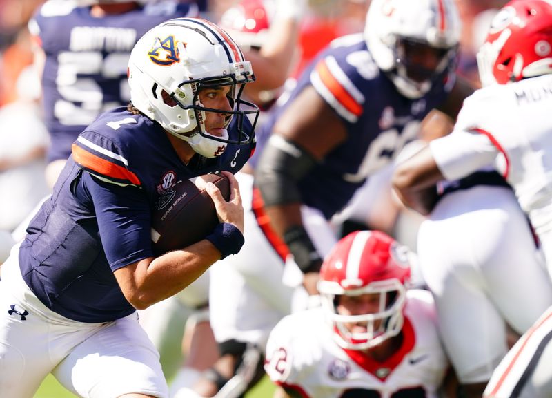 Sep 30, 2023; Auburn, Alabama, USA; Auburn Tigers quarterback Payton Thorne (1) scrambles up the field against the Georgia Bulldogs during the first quarter at Jordan-Hare Stadium. Mandatory Credit: John David Mercer-USA TODAY Sports