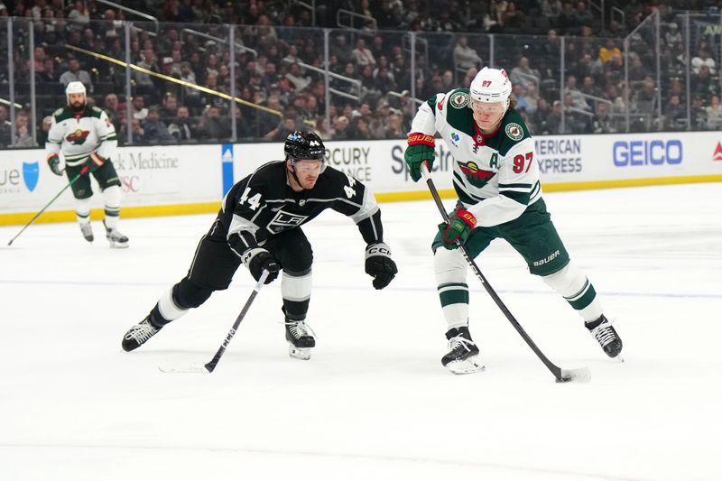 Apr 15, 2024; Los Angeles, California, USA; Minnesota Wild left wing Kirill Kaprizov (97) skates with the puck against LA Kings defenseman Mikey Anderson (44) in the first period at Crypto.com Arena. Mandatory Credit: Kirby Lee-USA TODAY Sports