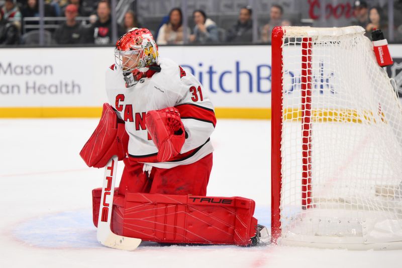 Oct 26, 2024; Seattle, Washington, USA; Carolina Hurricanes goaltender Frederik Andersen (31) blocks a Seattle Kraken goal shot during the first period at Climate Pledge Arena. Mandatory Credit: Steven Bisig-Imagn Images