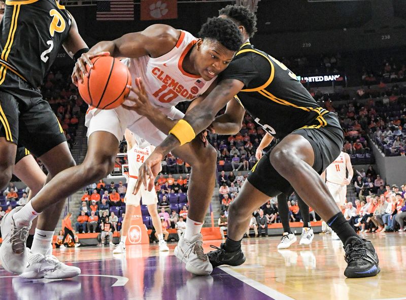 Feb 27, 2024; Clemson, South Carolina, USA;  Clemson sophomore RJ Godfrey (10) holds the ball near Pitt forward Blake Hinson (2) and Pitt forward Zack Austin (55) during the first half at Littlejohn Coliseum. Mandatory Credit: Ken Ruinard-USA TODAY Sports
