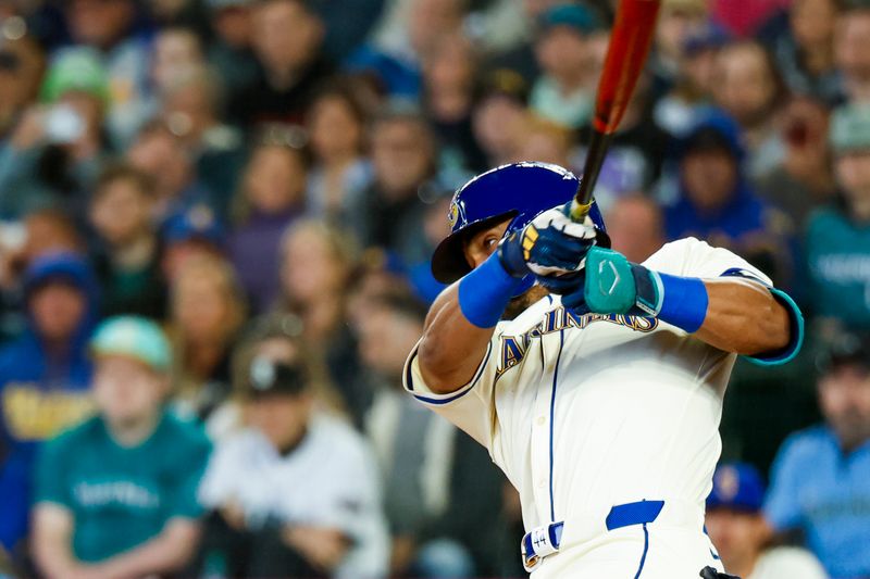 Apr 28, 2024; Seattle, Washington, USA; Seattle Mariners center fielder Julio Rodriguez (44) hits an RBI-single against the Arizona Diamondbacks during the third inning at T-Mobile Park. Mandatory Credit: Joe Nicholson-USA TODAY Sports