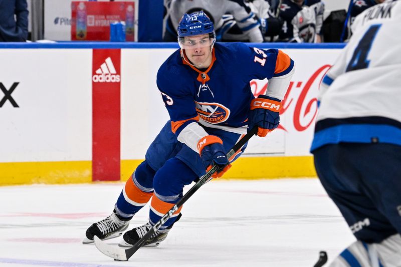 Mar 23, 2024; Elmont, New York, USA;  New York Islanders center Mathew Barzal (13) skates across the blue line against the Winnipeg Jets during the second period at UBS Arena. Mandatory Credit: Dennis Schneidler-USA TODAY Sports