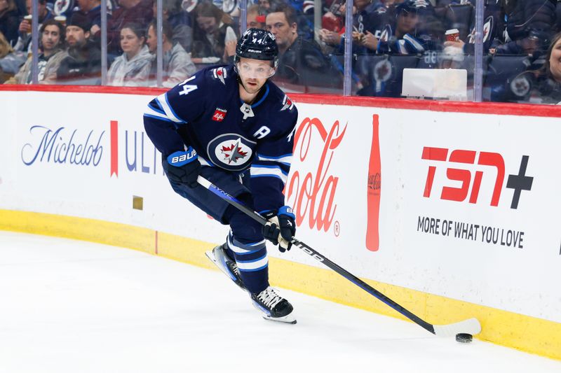 Mar 13, 2024; Winnipeg, Manitoba, CAN; Winnipeg Jets defenseman Josh Morrissey (44) looks to make a pass against the Nashville Predators during the first period at Canada Life Centre. Mandatory Credit: Terrence Lee-USA TODAY Sports