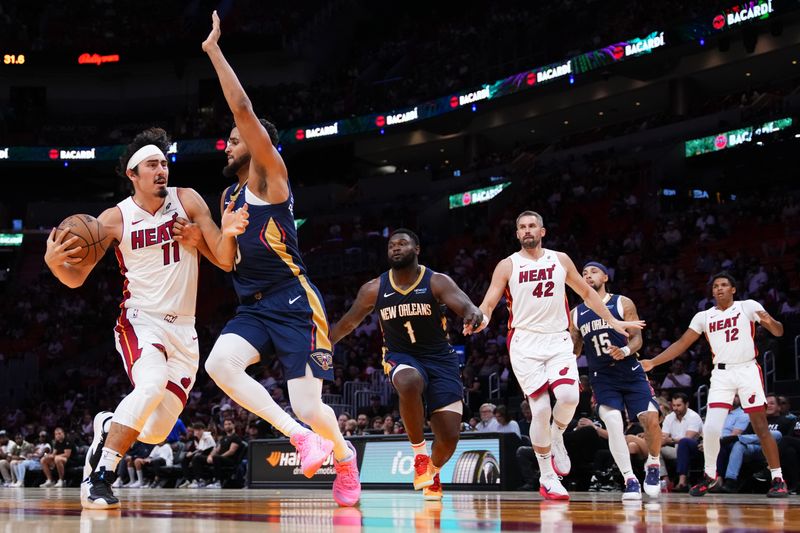 MIAMI, FLORIDA - OCTOBER 13: Jaime Jaquez Jr. #11 of the Miami Heat drives to the basket against Jeremiah Robinson-Earl #50 of the New Orleans Pelicans during the first quarter of a preseason game at Kaseya Center on October 13, 2024 in Miami, Florida. NOTE TO USER: User expressly acknowledges and agrees that, by downloading and or using this photograph, User is consenting to the terms and conditions of the Getty Images License Agreement. (Photo by Rich Storry/Getty Images)