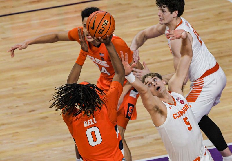 Feb 22, 2023; Clemson, South Carolina, USA; Syracuse forward Chris Bell (0) shoots against Clemson forward Hunter Tyson (5) during the first half at Littlejohn Coliseum. Mandatory Credit: Ken Ruinard-USA TODAY Sports