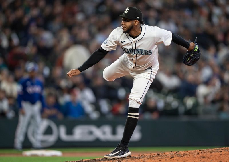 Jun 15, 2024; Seattle, Washington, USA; Seattle Mariners reliever Eduard Bazardo (83) delivers a pitch during the ninth inning against the Texas Rangers at T-Mobile Park. Mandatory Credit: Stephen Brashear-USA TODAY Sports