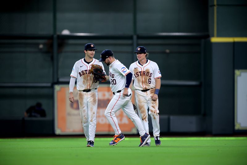 Jun 26, 2024; Houston, Texas, USA; Houston Astros outfielders celebrate after the final out against the Colorado Rockies during the ninth inning at Minute Maid Park. Mandatory Credit: Erik Williams-USA TODAY Sports