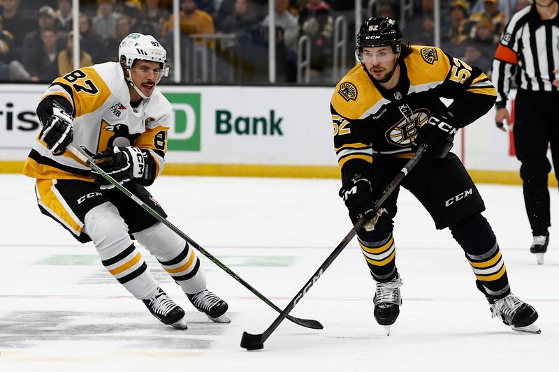 Nov 29, 2024; Boston, Massachusetts, USA; Boston Bruins defenseman Andrew Peeke (52) skates the puck past Pittsburgh Penguins center Sidney Crosby (87) during the first period at TD Garden. Mandatory Credit: Winslow Townson-Imagn Images