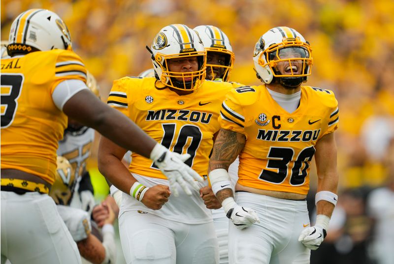 Sep 21, 2024; Columbia, Missouri, USA; Missouri Tigers linebacker Chuck Hicks (30) celebrates with teammates after a sack during the first half against the Vanderbilt Commodores at Faurot Field at Memorial Stadium. Mandatory Credit: Jay Biggerstaff-Imagn Images