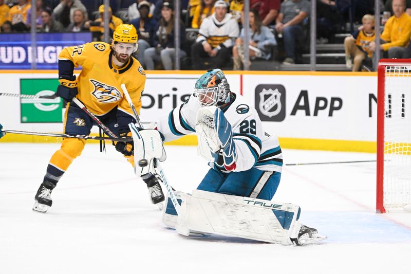 Oct 21, 2023; Nashville, Tennessee, USA; San Jose Sharks goaltender Mackenzie Blackwood (29) deflects the shot of Nashville Predators left wing Samuel Fagemo (11) during the first period at Bridgestone Arena. Mandatory Credit: Steve Roberts-USA TODAY Sports