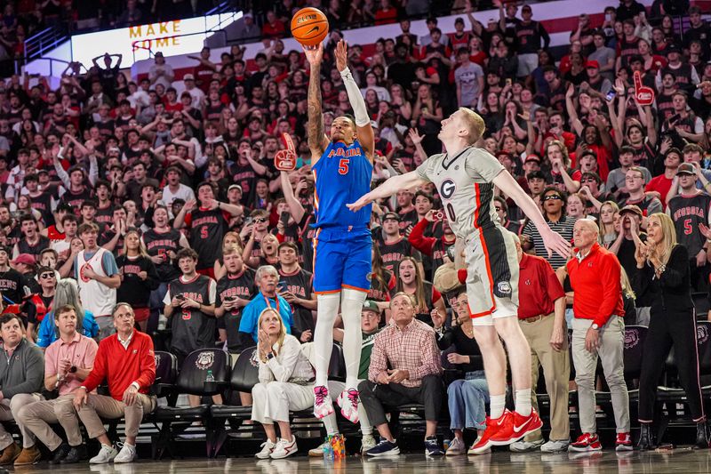 Feb 25, 2025; Athens, Georgia, USA; Florida Gators guard Will Richard (5) shoots over Georgia Bulldogs guard Blue Cain (0) during the second half at Stegeman Coliseum. Mandatory Credit: Dale Zanine-Imagn Images