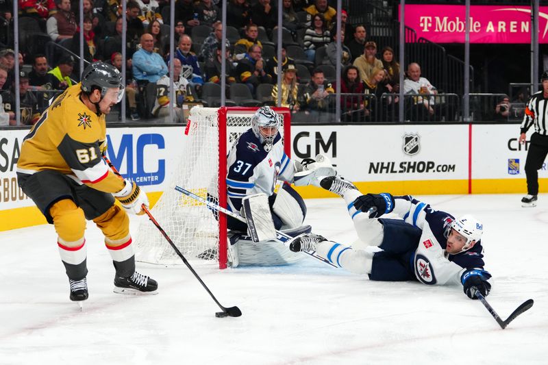 Nov 2, 2023; Las Vegas, Nevada, USA; Winnipeg Jets goaltender Connor Hellebuyck (37) defends his net as Winnipeg Jets defenseman Dylan DeMelo (2) slides to block a centering pass from Vegas Golden Knights right wing Mark Stone (61) during the first period at T-Mobile Arena. Mandatory Credit: Stephen R. Sylvanie-USA TODAY Sports