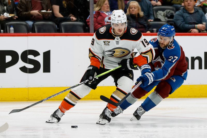 Dec 5, 2023; Denver, Colorado, USA; Anaheim Ducks right wing Troy Terry (19) controls the puck under pressure from Colorado Avalanche left wing Jonathan Drouin (27) in the third period at Ball Arena. Mandatory Credit: Isaiah J. Downing-USA TODAY Sports