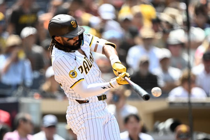 Aug 21, 2025; San Diego, California, USA; San Diego Padres right fielder Fernando Tatis Jr. (23) hits a double during the fourth inning against the San Francisco Giants at Petco Park. Mandatory Credit: Denis Poroy-Imagn Images