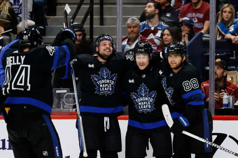 Feb 24, 2024; Denver, Colorado, USA; Toronto Maple Leafs left wing Tyler Bertuzzi (59) celebrates his hat trick goal with center Auston Matthews (34) and right wing William Nylander (88) and defenseman Morgan Rielly (44) in the third period against the Colorado Avalanche at Ball Arena. Mandatory Credit: Isaiah J. Downing-USA TODAY Sports