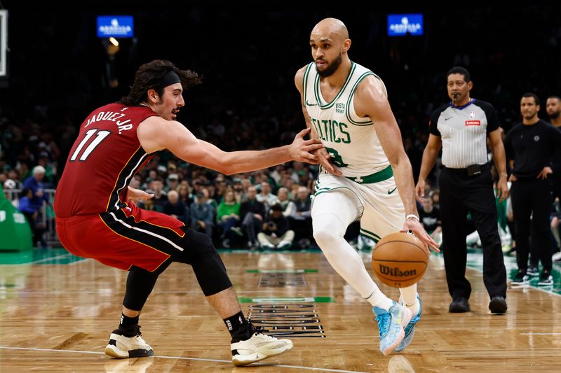 BOSTON, MA - APRIL 21: Jaime Jaquez Jr. #11 of the Miami Heat tries to stop Derrick White #9 of the Boston Celtics from going past him during the second half of game one of the Eastern Conference First Round Playoffs at TD Garden on April 21, 2024 in Boston, Massachusetts. NOTE TO USER: User expressly acknowledges and agrees that, by downloading and/or using this Photograph, user is consenting to the terms and conditions of the Getty Images License Agreement. (Photo By Winslow Townson/Getty Images)