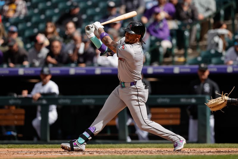 Apr 10, 2024; Denver, Colorado, USA; Arizona Diamondbacks designated hitter Ketel Marte (4) hits a single in the seventh inning against the Colorado Rockies at Coors Field. Mandatory Credit: Isaiah J. Downing-USA TODAY Sports