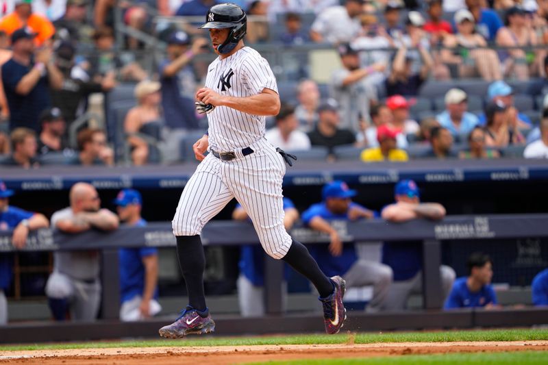 Jul 8, 2023; Bronx, New York, USA; New York Yankees right fielder Giancarlo Stanton (27) scores a run on New York Yankees center fielder Harrison Bader   s (not pictured) RBI double against the Chicago Cubs during the third inning at Yankee Stadium. Mandatory Credit: Gregory Fisher-USA TODAY Sports